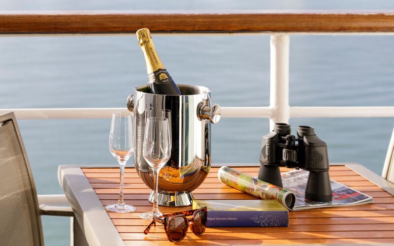 A table with champagne, water and binoculars