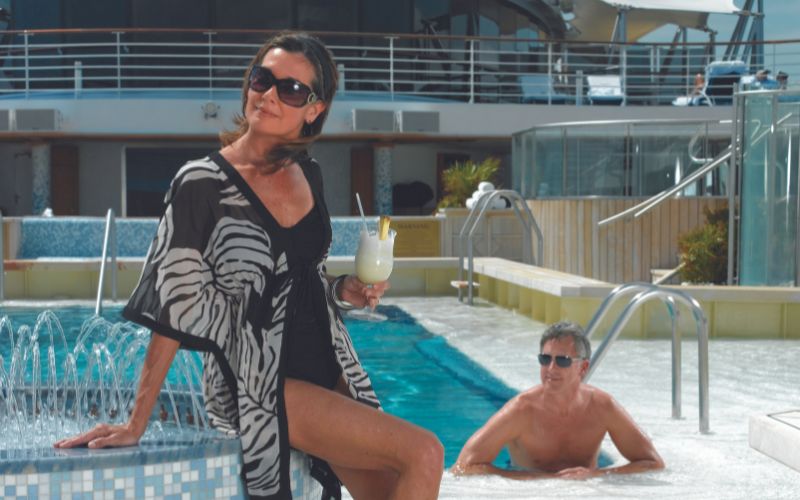 couple enjoying the pool deck -  Oceania cruise ship