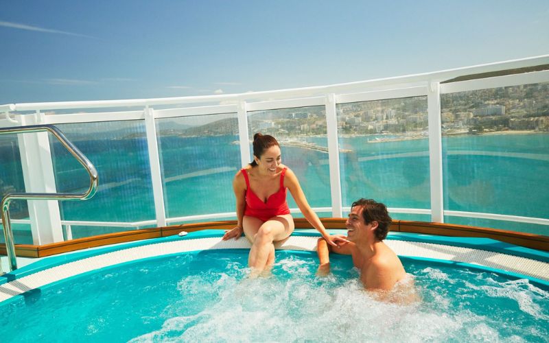 couple on a cruise enjoying the hot tub