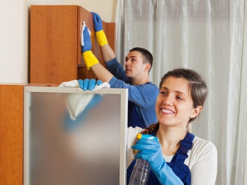 cruise ship cleaners cleaning a cabin wearing rubber gloves