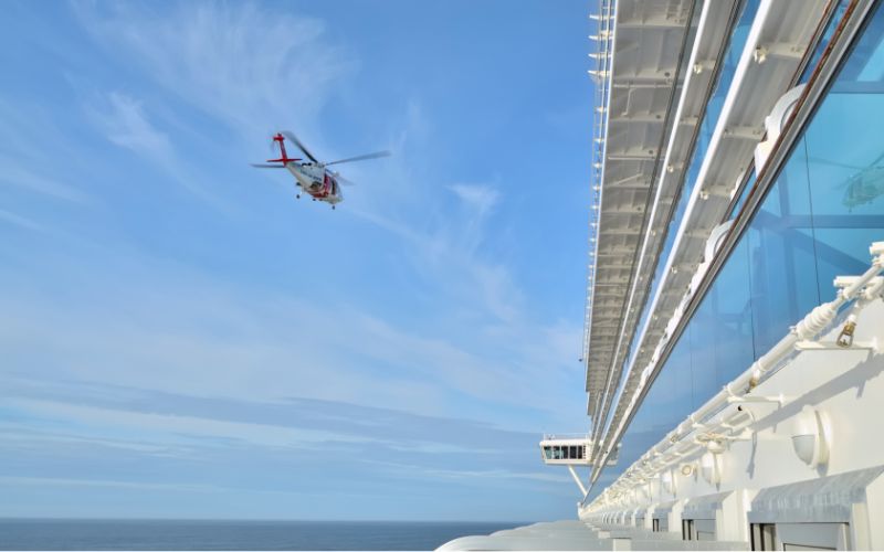 helicopter next to a cruise ship