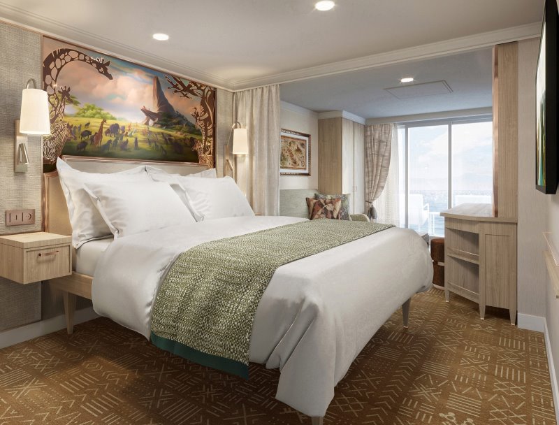 Elegantly appointed Disney Treasure Concierge Stateroom with Verandah, featuring a plush queen bed with a whimsical Tangled-themed mural overhead, refined furnishings, and a glimpse of the ocean through the verandah door.