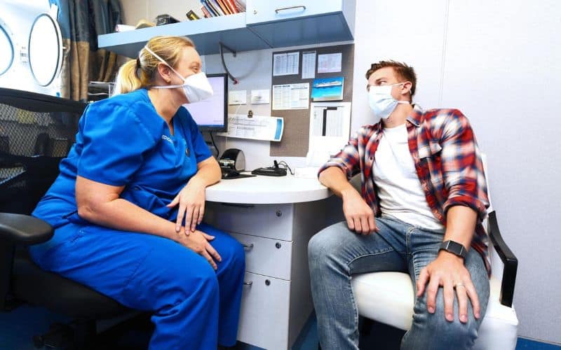 doctor and patient talking on cruise ship