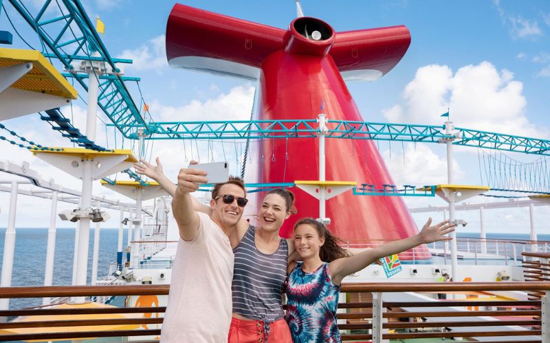 family taking a photo on board a cruise ship