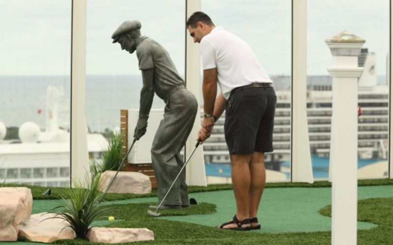 Man playing golf onboard Royal Caribbean's Oasis of the Seas