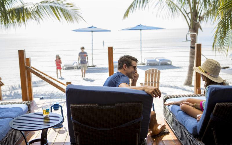 Family relaxing at the beach front cabana in Harvest Caye