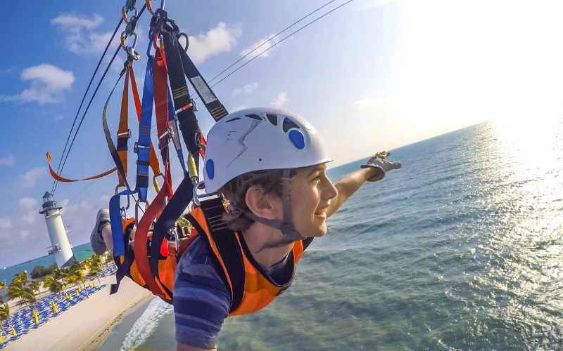 Kid enjoying the zip line at Harvest Caye