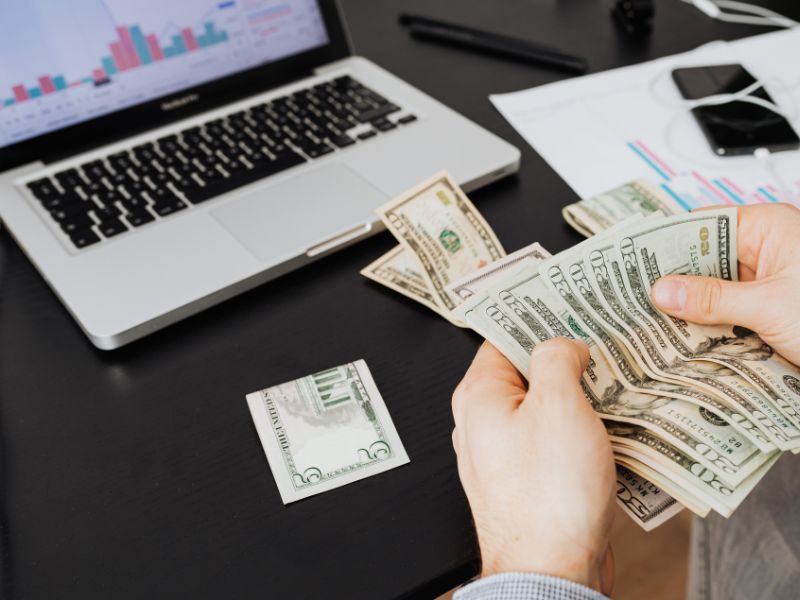 A person counting up the money before paying