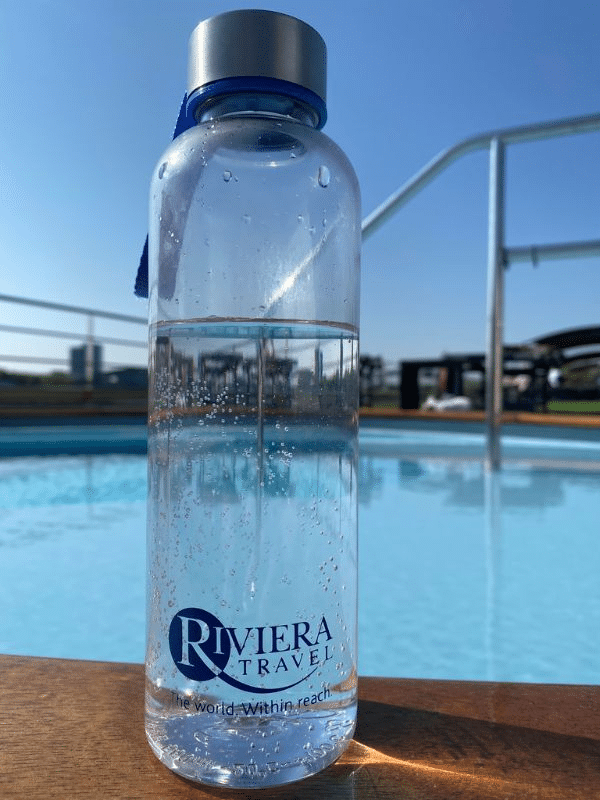 Riviera Cruises water bottle pictured on the side of the swimming pool