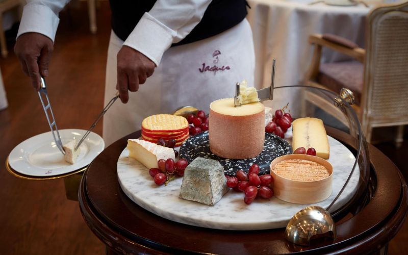 waiter serving cheese