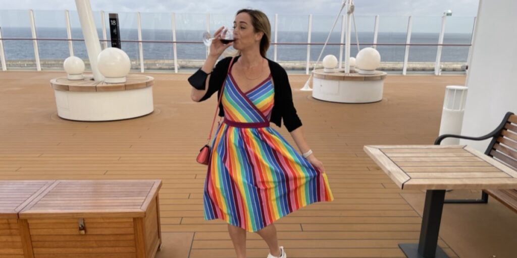Me walking around a cruise ship with a glass of wine