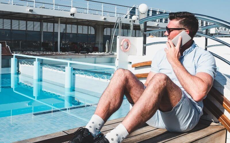 Man using his phone on a cruise ship