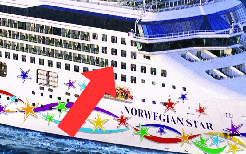 The midsection of the Norwegian Star cruise ship sailing on the water, prominently displaying the name 'Norwegian Star' on the hull with colorful stars and a large red arrow graphic overlaid on the image, highlighting the enclosed balconies.