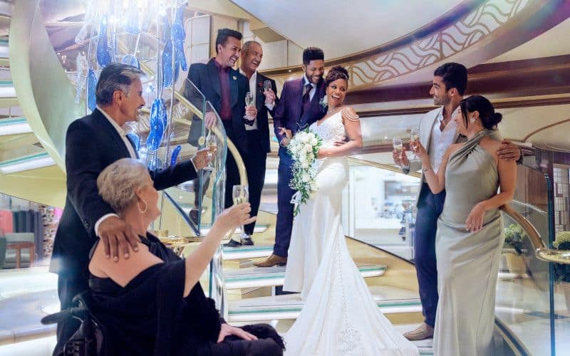 newly weds with their guests sharing a happy moment at after the cermony