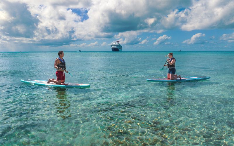 couple having fun on a paddle boat at Princess Cays beach