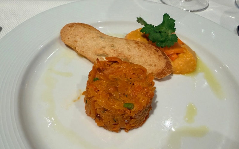 Plated carrot rosti starter with toast and a parsley garnish.