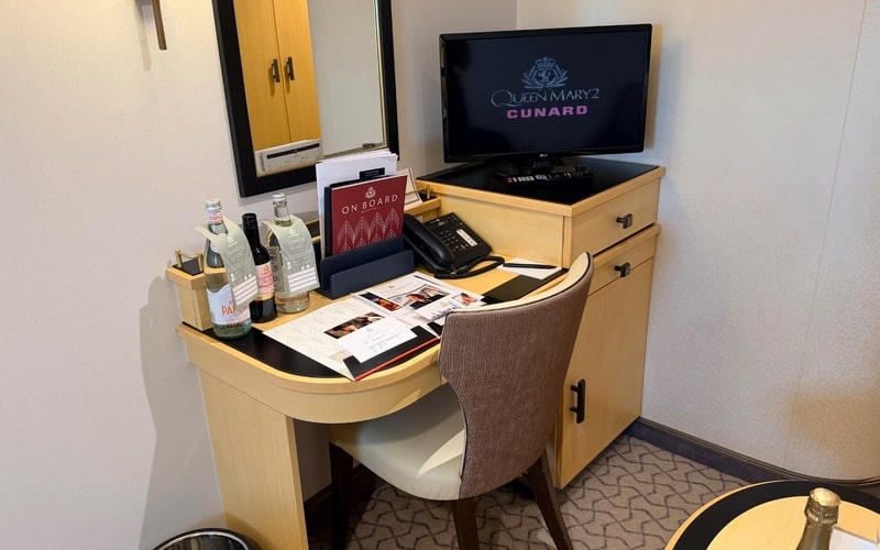 Desk, chair and television in a Queen Mary 2 cabin.