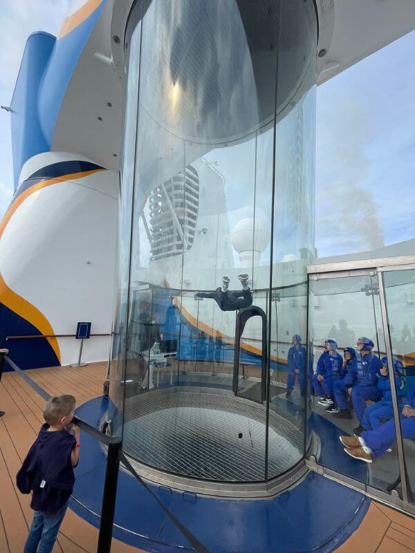 a boy looking at skydiving simulation tube