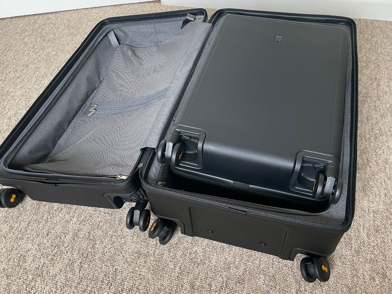 The large suitcase can fit the smaller suitcase inside