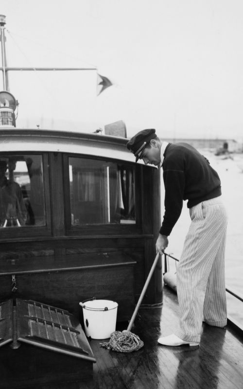 A sailor mopping the deck