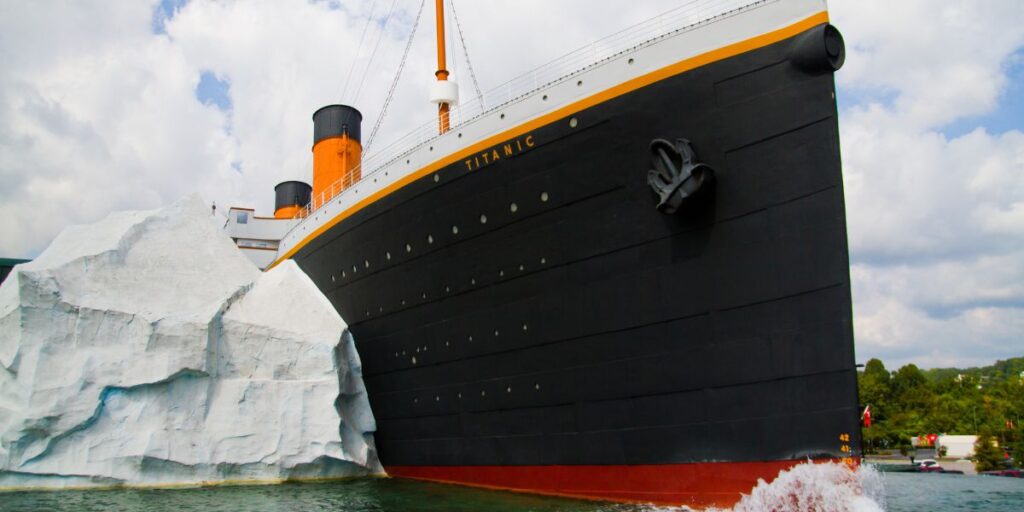 A replica of the Titanic crashing against a large iceberg