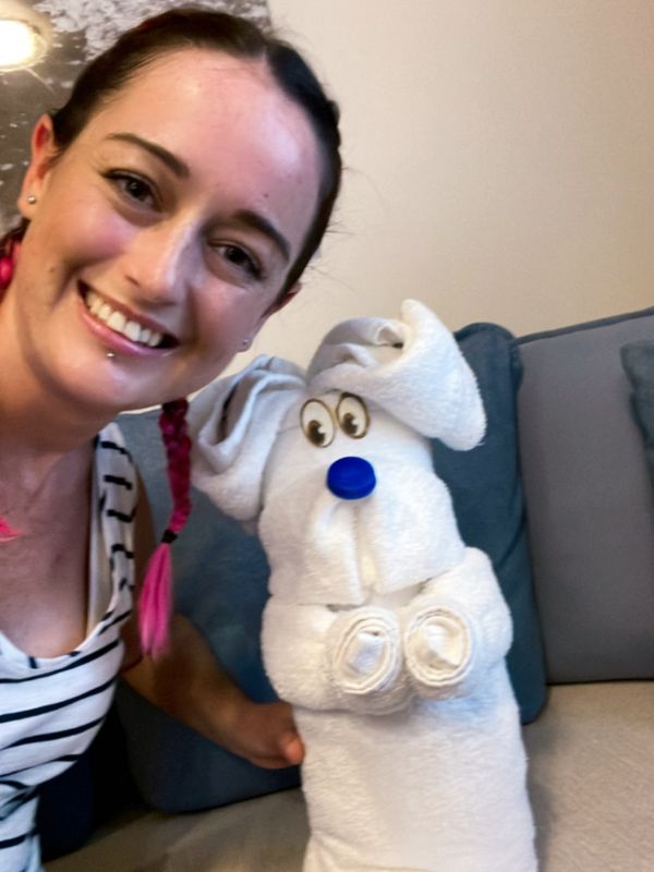 smiling woman with a dog towel animal