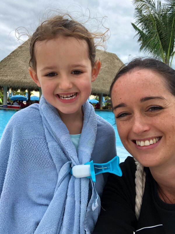 Child wrapped in pool towel on cruise line private island